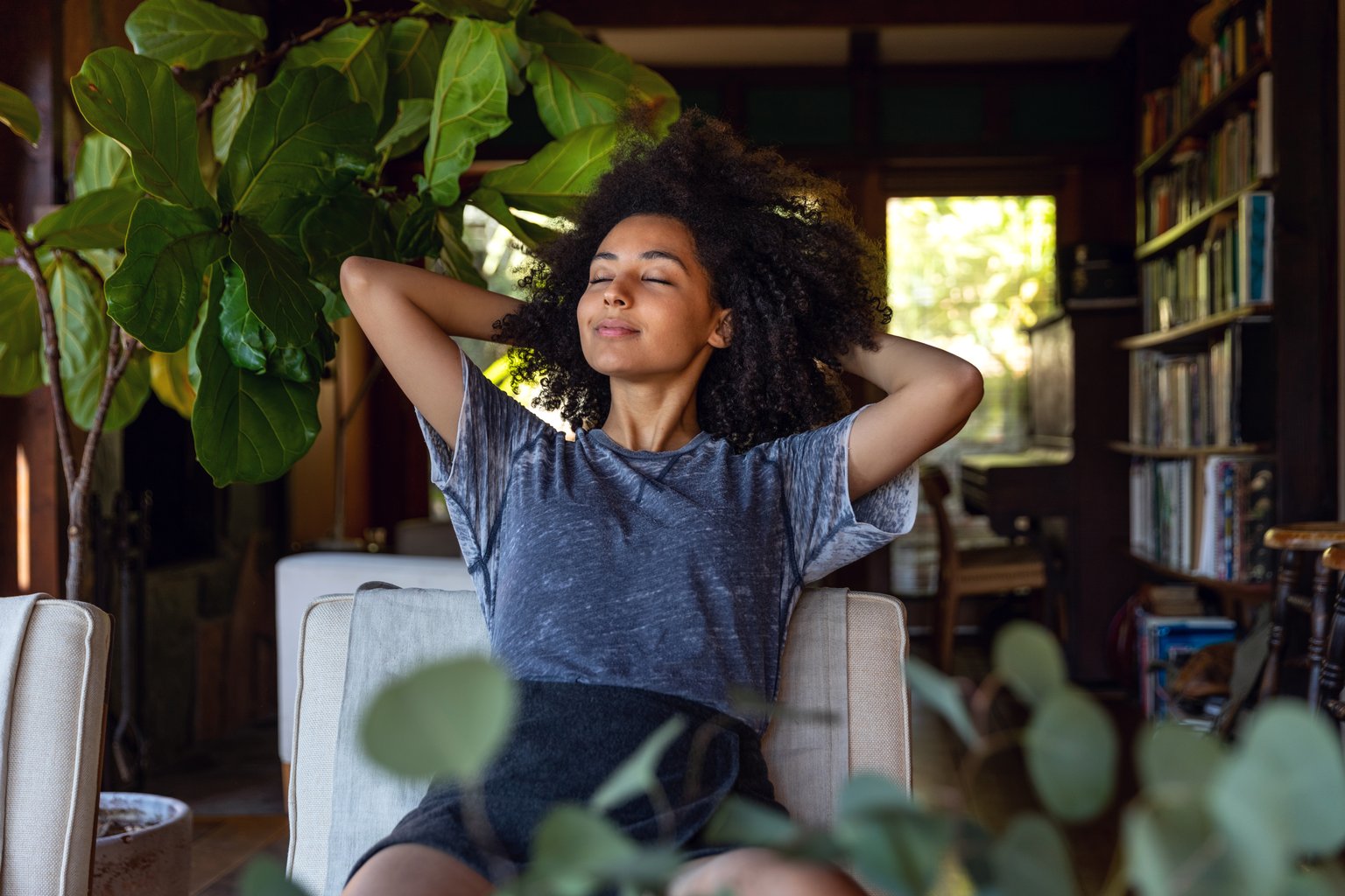 Woman smiling and sitting with her eyes shut after being treated for congestion and stuffy nose