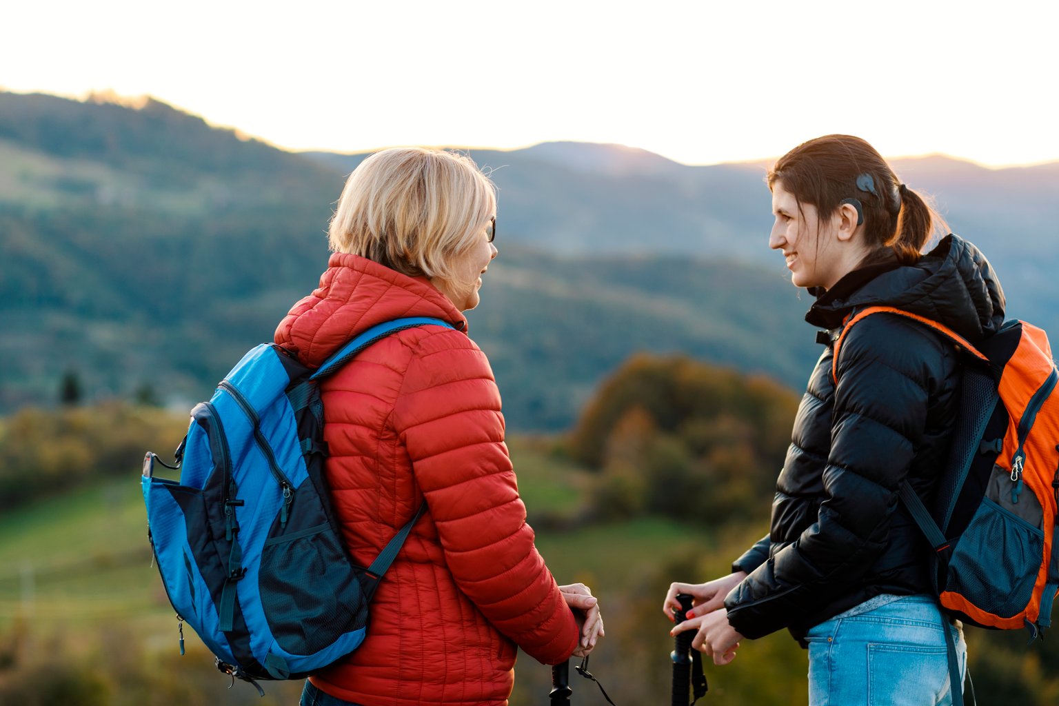 Woman with implantable hearing aid on a hike with their mother