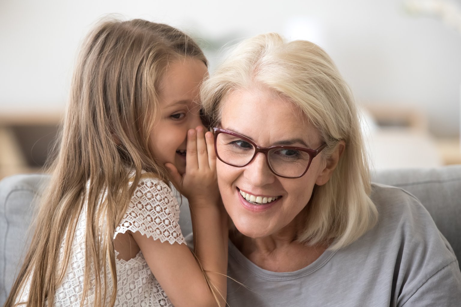 Grandmother listening to grandchild speak after being treated for otosclerosis